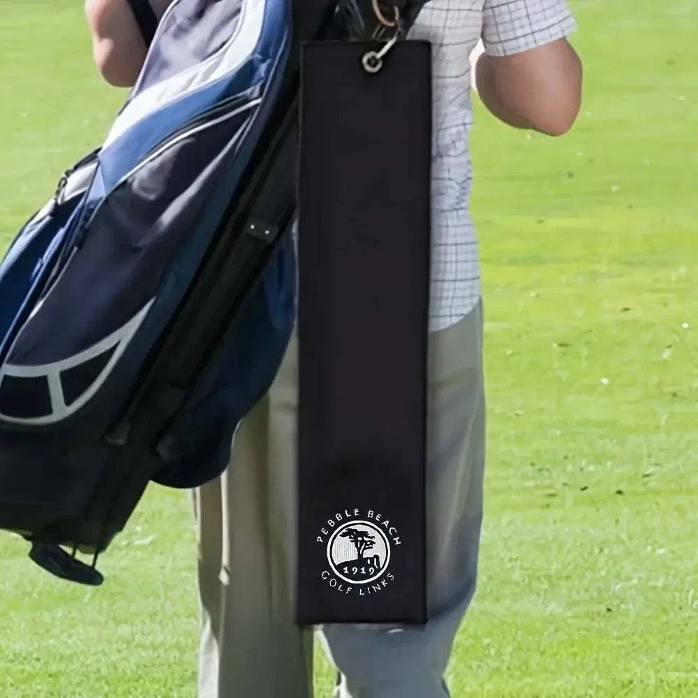 Embroidered 1919 Golf Towel with Clip attached to a golf bag on the course.