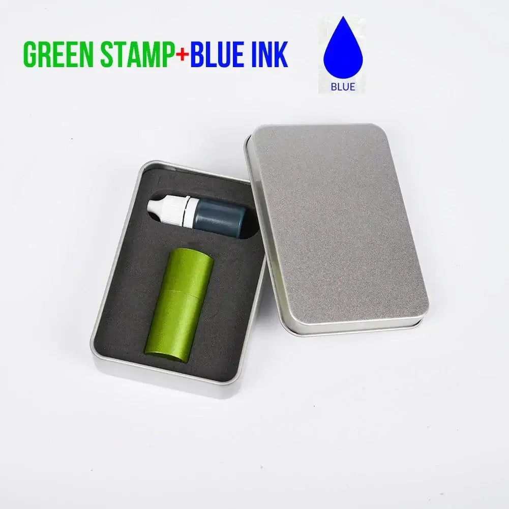 Custom Golf Ball Stamp with green handle and blue ink in a metal storage case.