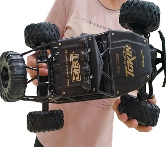 Remote control cars with LED lights held by a person, showcasing the 4WD design and rugged tires.