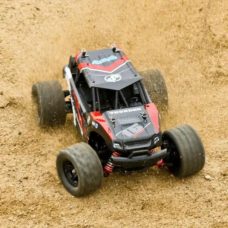 Remote Control Car - All-Terrain speeding over sandy terrain with spinning wheels and dirt flying.