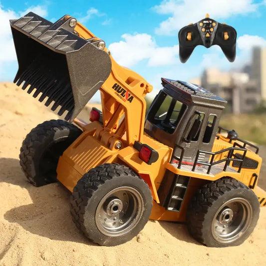 HUINA 118 RC Bulldozer with remote control, showcasing detailed alloy shovel and realistic design in sandy terrain.