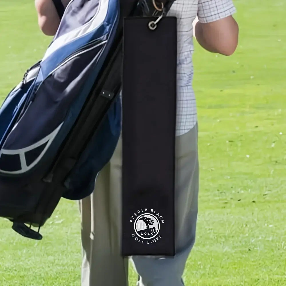 Embroidered 1919 Golf Towel with Clip attached to a golf bag on the course.