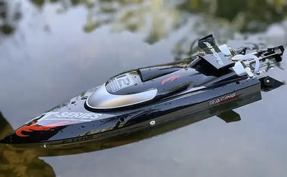 Large RC Speed Boat FT011 FT012 FT016 WL916 floating on water, showcasing sleek design and racing features.