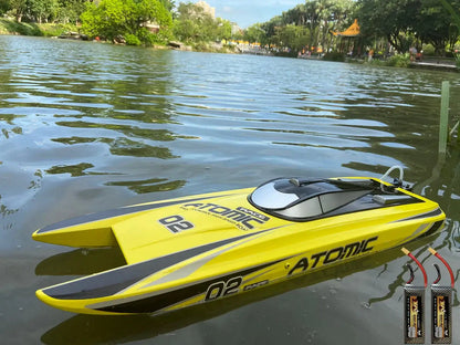 Large Remote Control Boat 27.6 inch RTR Atomic SR65B racing on water with vibrant yellow design.