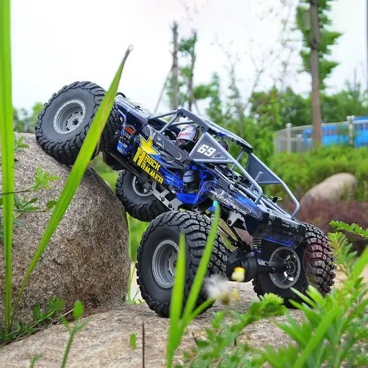 110 Scale Professional Simulation Rgt Hobby Remote Control climbing a rock in a lush outdoor setting.