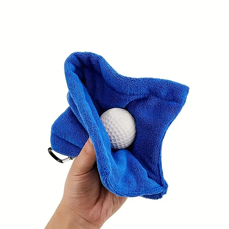 1pc Golf Towel Golf Cleaning Towel being held with a golf ball inside, showcasing its cleaning capability and hook for convenience.