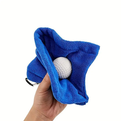 1pc Golf Towel Golf Cleaning Towel being held with a golf ball inside, showcasing its cleaning capability and hook for convenience.