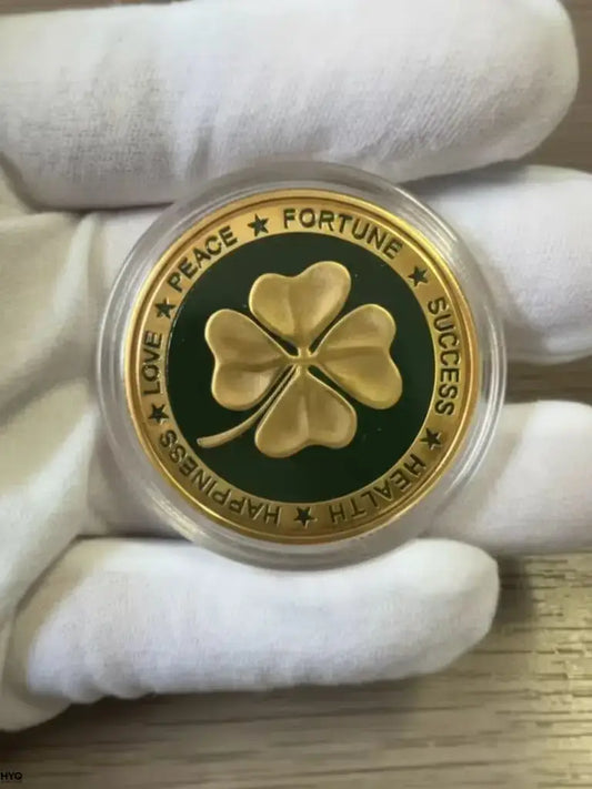 four leaf clover commemorative coin featuring a golden clover design with inscriptions for peace, fortune, and success.