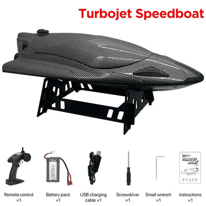 Turbojet Speedboat 40KMh displayed with remote control, battery pack, USB cable, screwdriver, small wrench, and instructions.