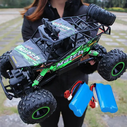 RC Car Remote Control Climbing Vehicle held by a person with batteries, showcasing all terrain capabilities and rugged design.