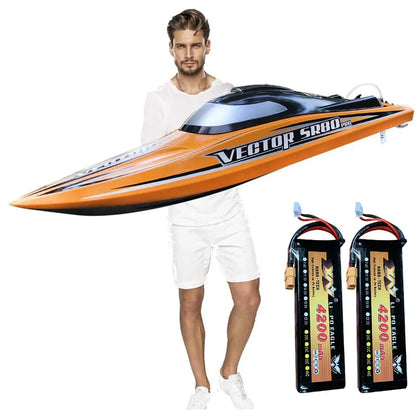 Man holding Vector SR80 Pro RC boat with two 4200 batteries, showcasing SR80 Pro. RTR 31.5 RC Boat.