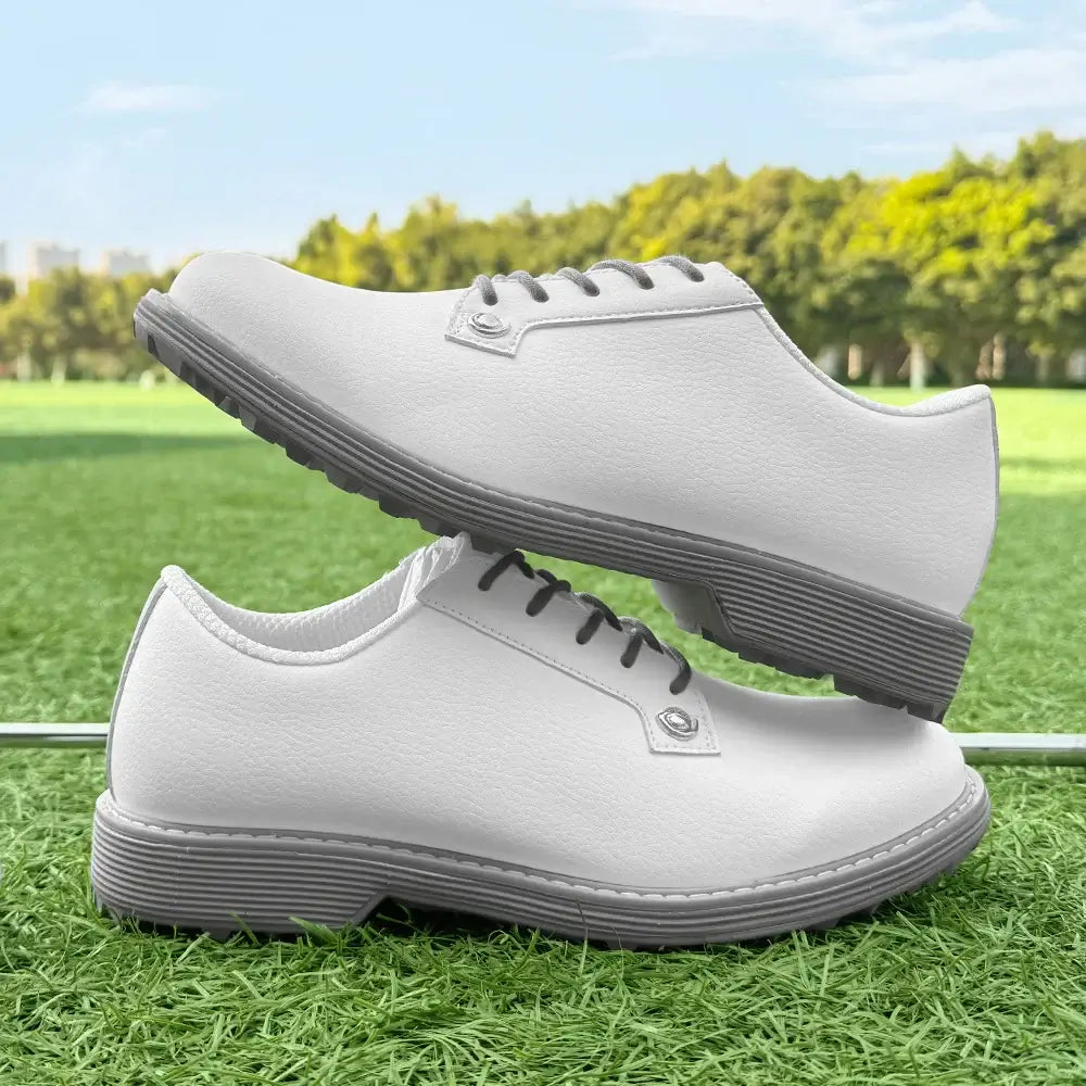 women's leather golf shoes displayed on a golf course grass background for comfortable golfer footwear.