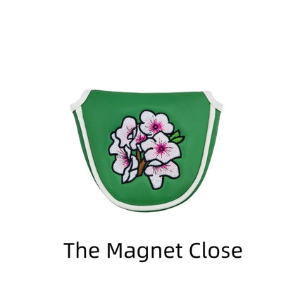 Flower embroidery golf club head covers in green with delicate floral design, perfect for protecting golf club heads.