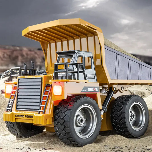 Huina 533D Alloy Remote Control Dump Truck showcasing a detailed design and strong power in a sandy environment.