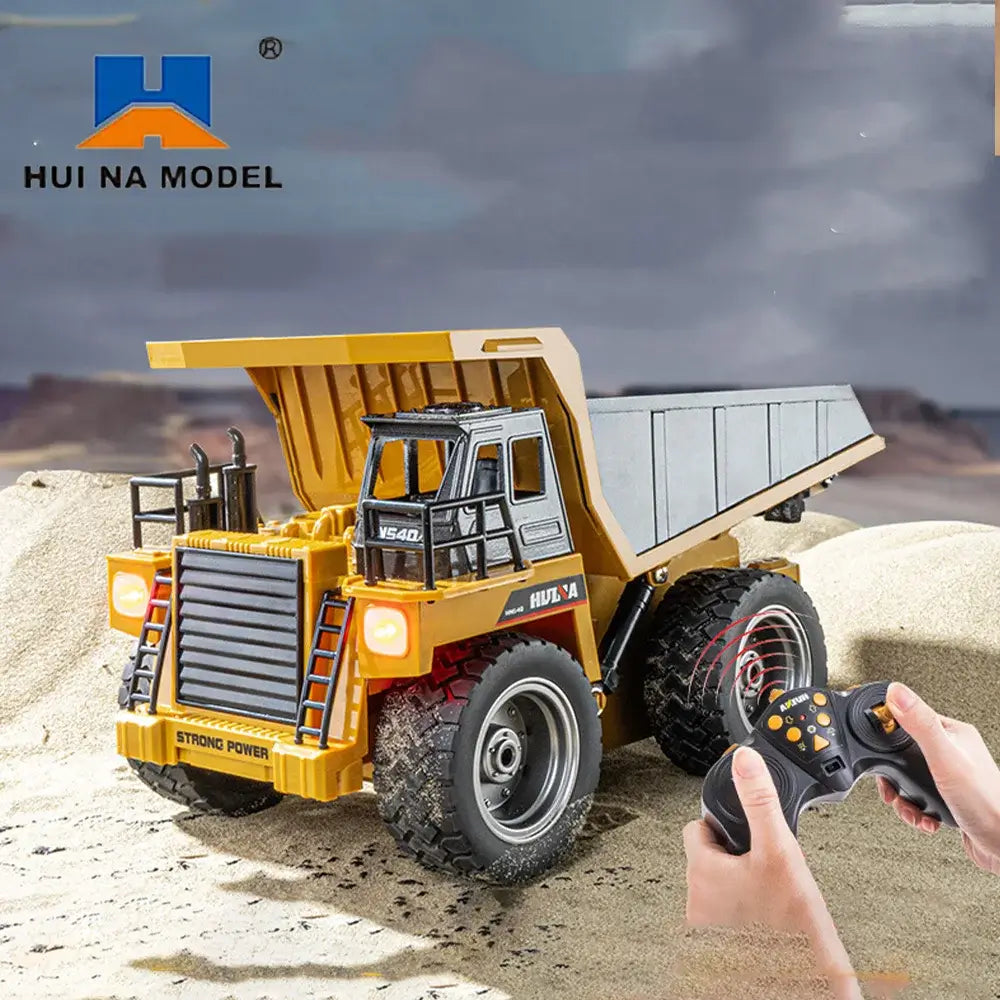Huina 1534 Rc Truck Tractor remote control dump truck in action with a controller on sandy terrain