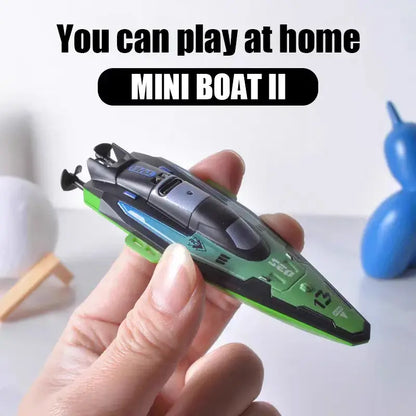 RC Boats Mini showing a hand holding the green MINI BOAT II remote control speedboat for home play.
