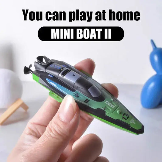RC Boats Mini showing a hand holding the green MINI BOAT II remote control speedboat for home play.