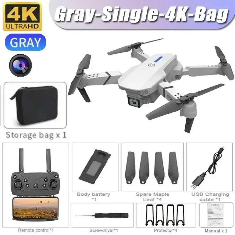 4K dual camera RC drone in gray color with accessories including remote control and storage bag for aerial photography.
