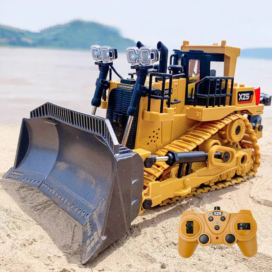 RC bulldozer remote control truck with realistic details and remote control on sand.