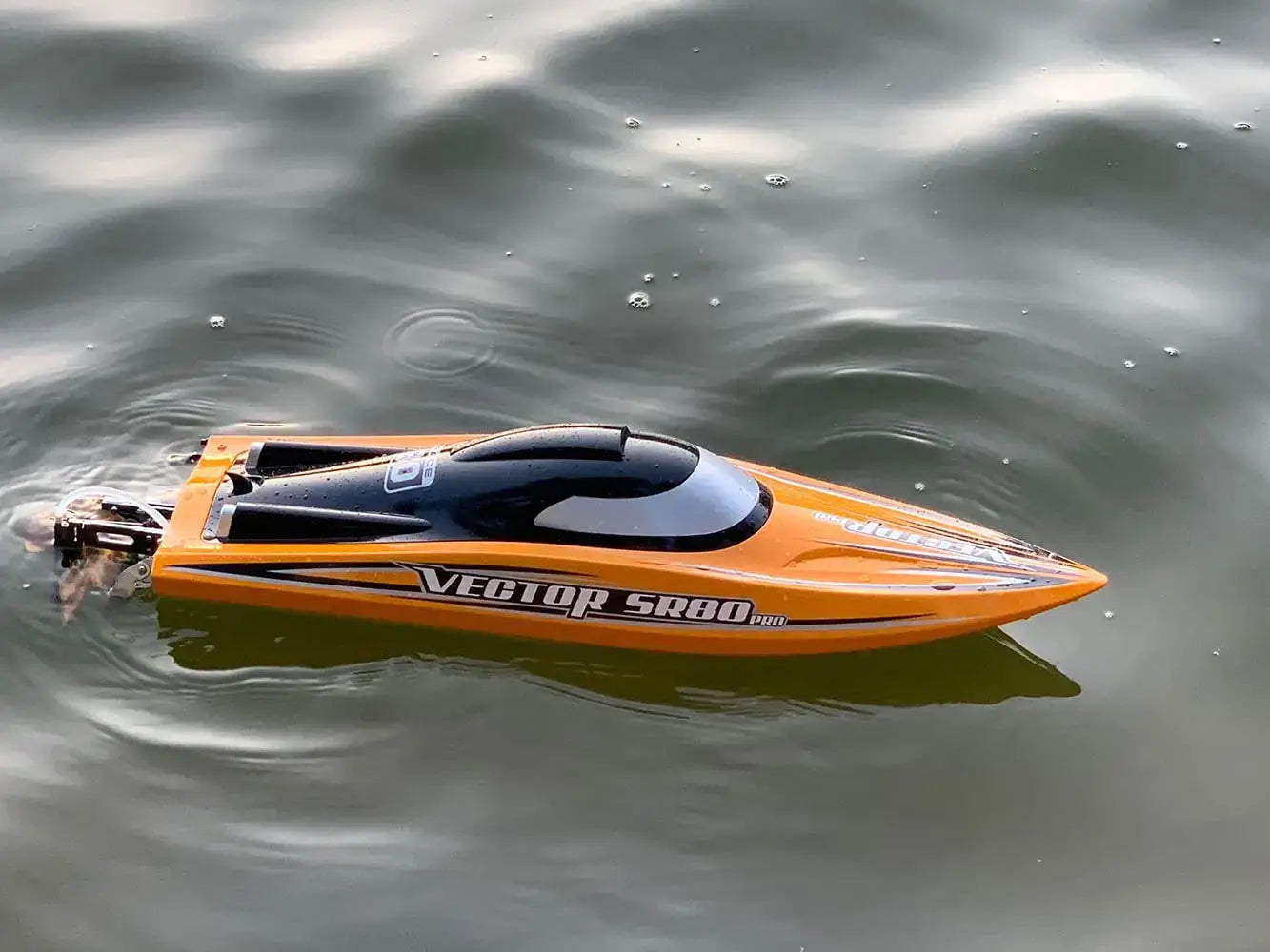 SR80 Pro. RTR 31.5 RC Boat gliding on water, showcasing its sleek design and performance.