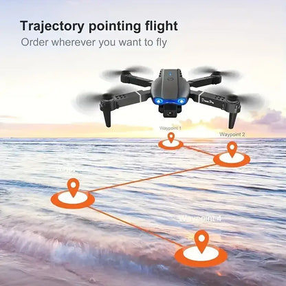 E99 PRO drone with dual camera flying over ocean with trajectory points and waypoints marked on the water surface.