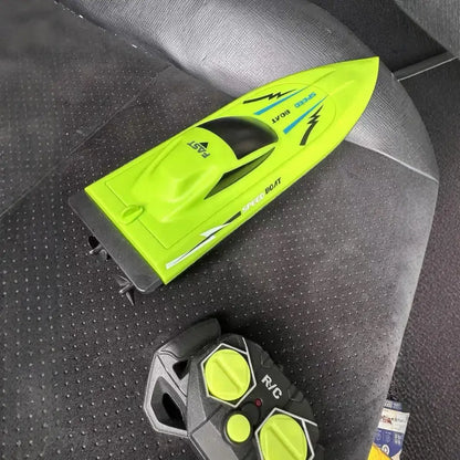 Remote Control Boat Submersible Children's High Speed sitting next to its remote control on a car seat.
