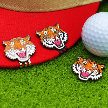 golf ball marker hat clip featuring tiger design on red cap with golf ball on green grass