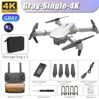 New E88 RC Drone in gray with 4K camera, remote control, storage bag, and accessories laid out for aerial photography.