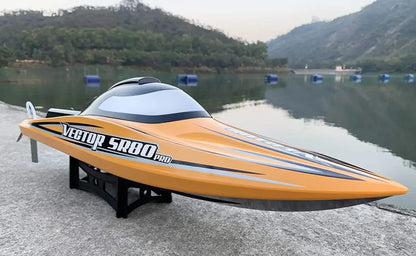 SR80 Pro. RTR 31.5 RC Boat displayed by the water with a sleek orange design.