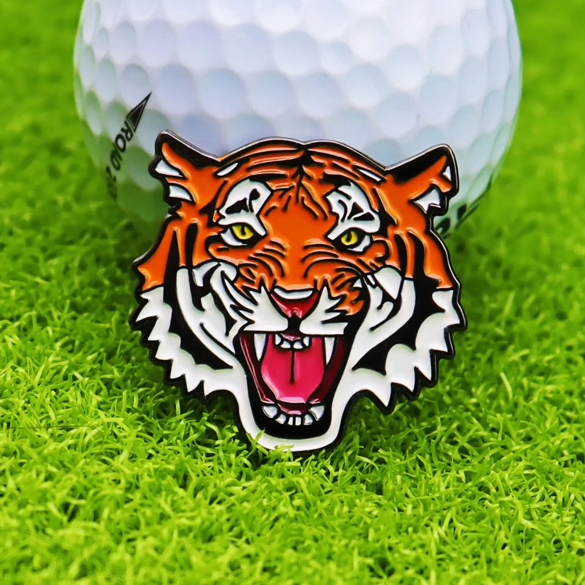 golf ball marker hat clip featuring a colorful tiger design on a golf course background