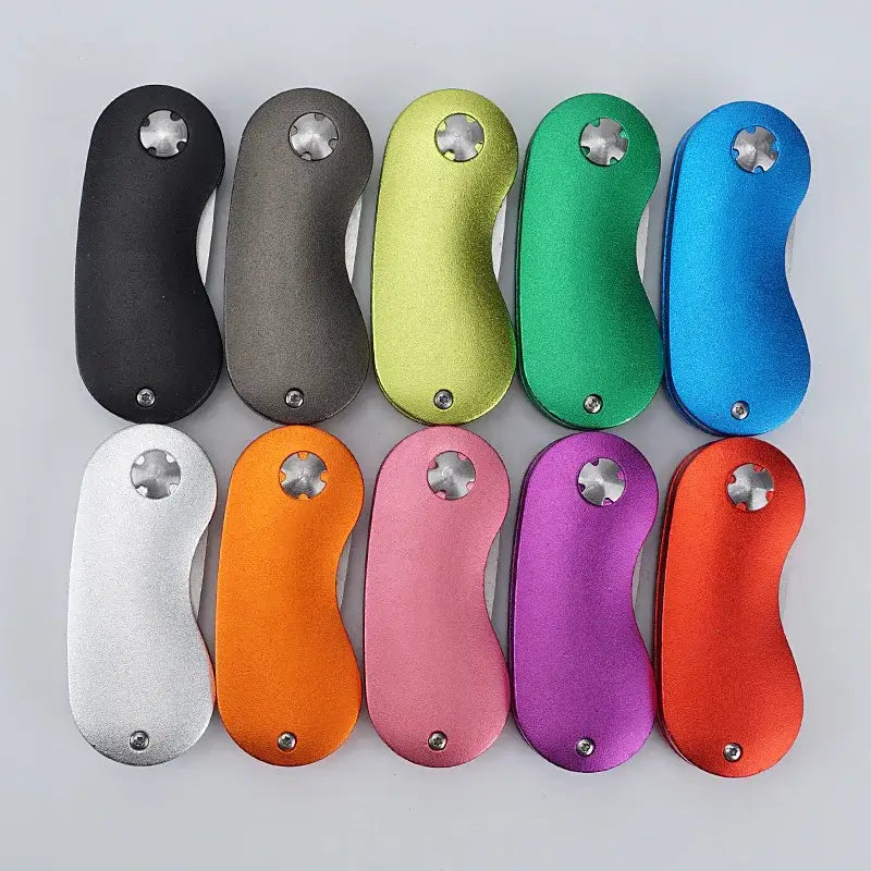 Metal Foldable Golf Divot Repair Tool in various colors, showcasing multiple options in a flat lay arrangement.