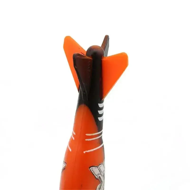 Close-up of an orange torpedo-shaped underwater throwing toy for kids.