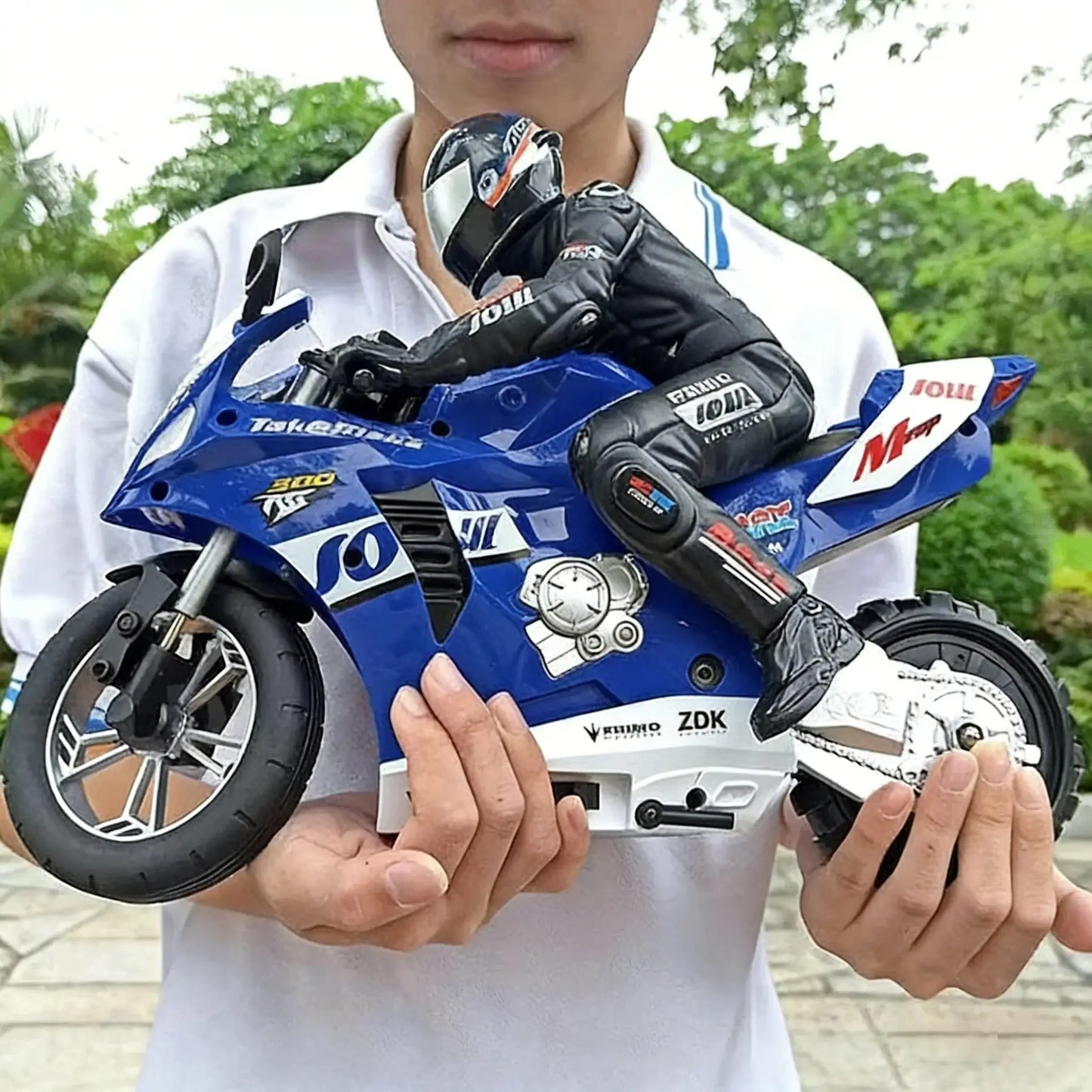 RC Motorcycles 16 110 Electric model being held by a person outdoors, showcasing detailed design and remote control features.