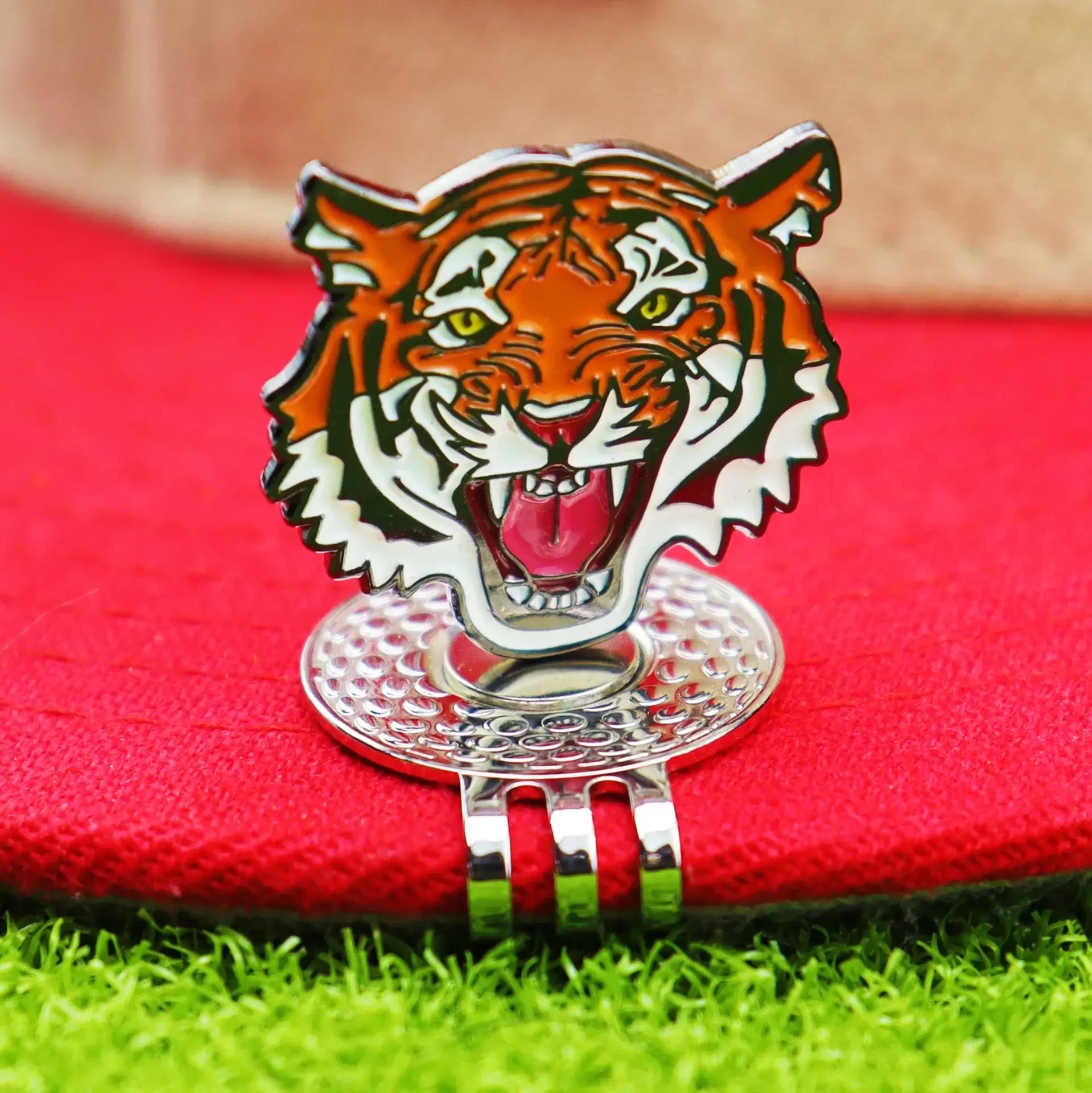golf ball marker hat clip featuring a fierce tiger design on a red cap