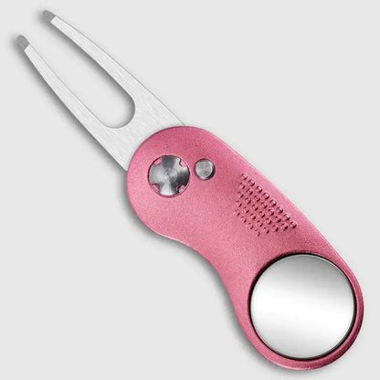 Metal Foldable Golf Divot Repair Tool in pink with a forked end and built-in mirror design.