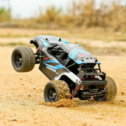 Remote Control Car - All-Terrain performing a wheelie on sandy terrain