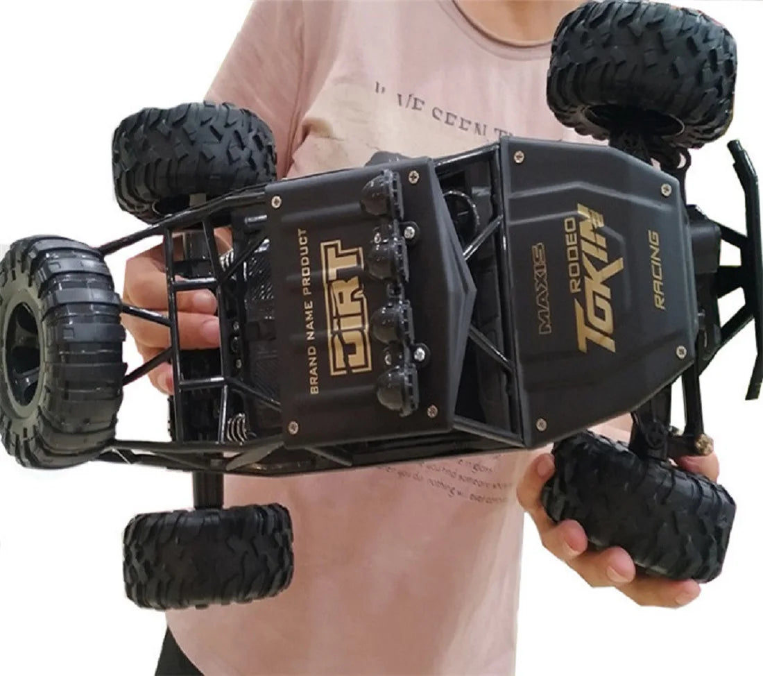 Remote control cars with LED lights held by a person, showcasing the 4WD design and rugged tires.