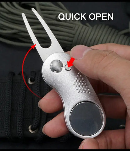 Hand holding a Metal Foldable Golf Divot Repair Tool demonstrating quick open feature.