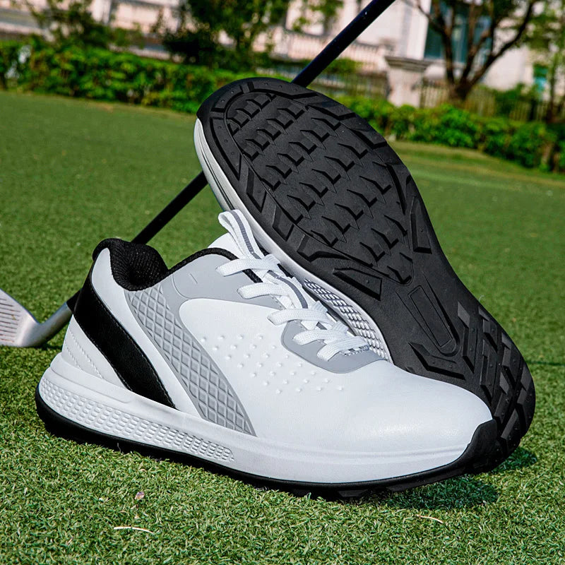 unisex waterproof golf shoes resting on grass, designed for comfort and performance in outdoor sports.