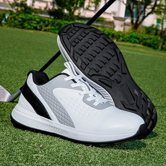 unisex waterproof golf shoes resting on grass, designed for comfort and performance in outdoor sports.
