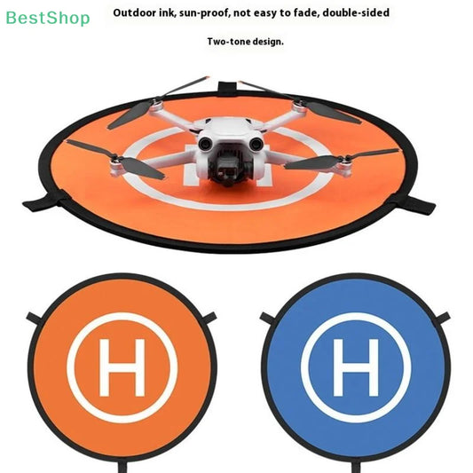 Drone Landing Pad in orange and blue double-sided waterproof Oxford fabric with a foldable design, featuring a white H landing symbol and a white DJI drone on the orange side