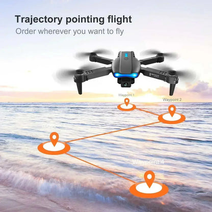 PRO MAX foldable drone E88 black compact quadcopter with dual cameras in flight showing trajectory waypoint navigation over water